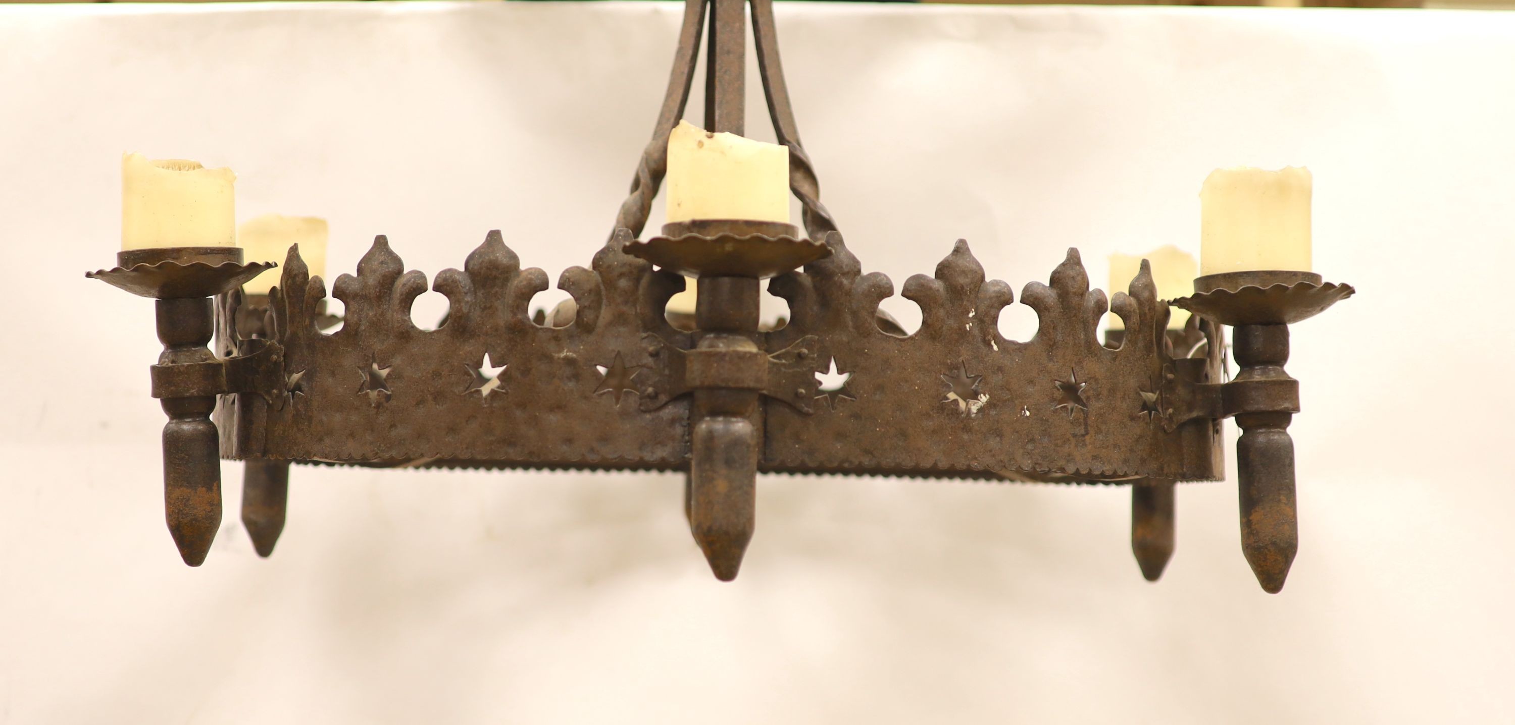 A 19th century wrought iron chandelier, approximately 83 cm across